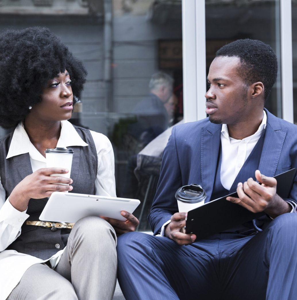 portrait-young-african-businessman-businesswoman-sitting-together-outside-office